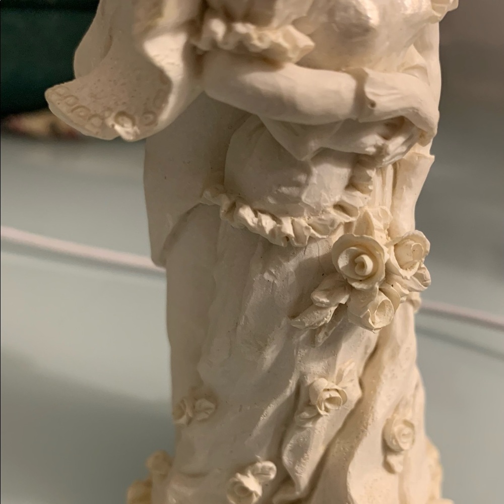 Gorgeous figurine of a couple holding ea. other. Wedding cake topper / Sculpture